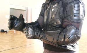 Man putting on protective glove that matches his combat gear