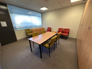 Small meeting room showing table and eight chairs